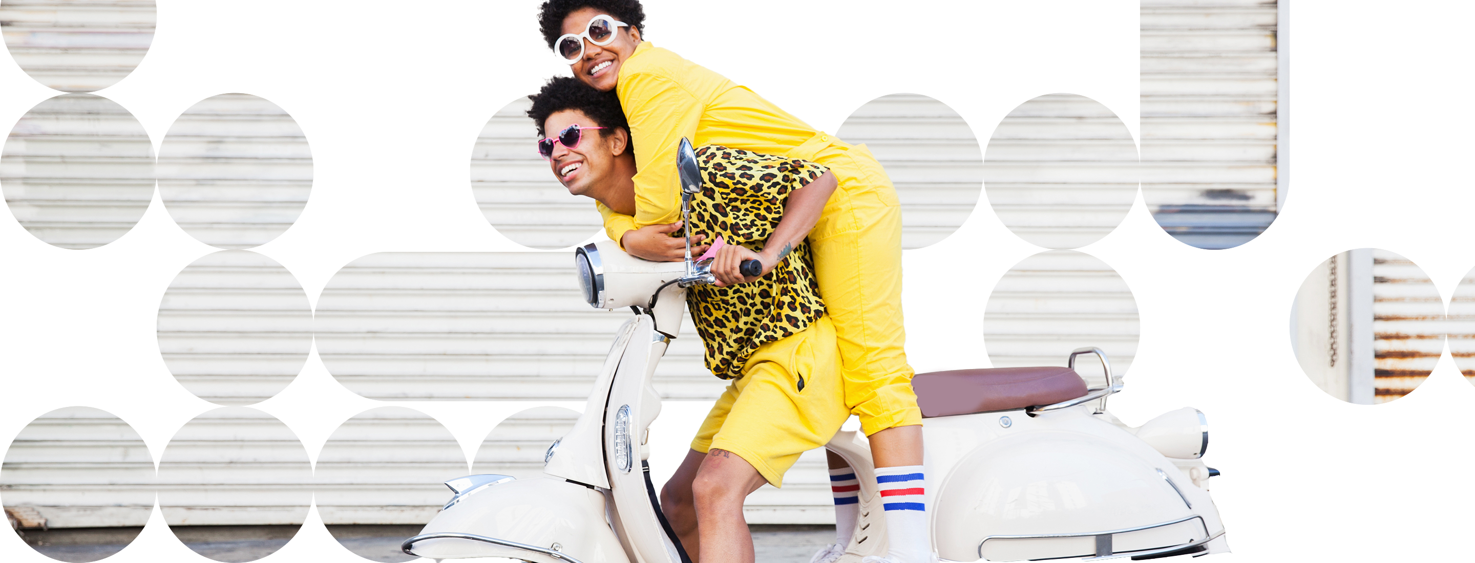 Two people, both dressed in yellow and wearing sunglasses, riding a white motor scooter, against a background of geometric shapes.