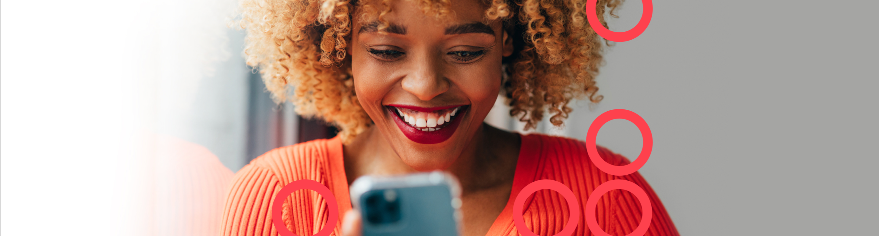 Woman smiling while using her smart phone