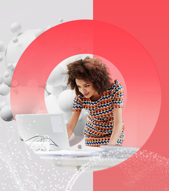 A young professional woman reads something on her laptop at work.
