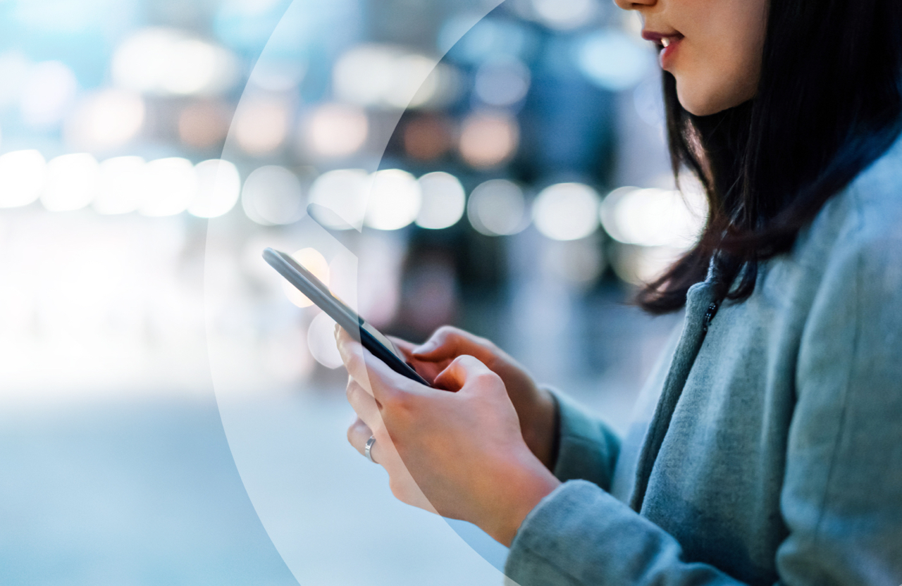 Woman in public space on a smart phone