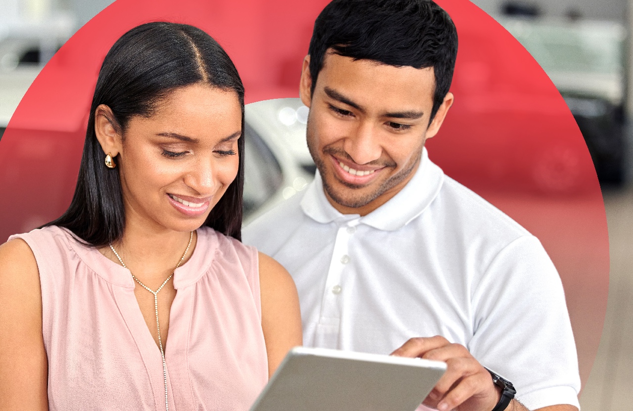 couple looking at a tablet to buy a car