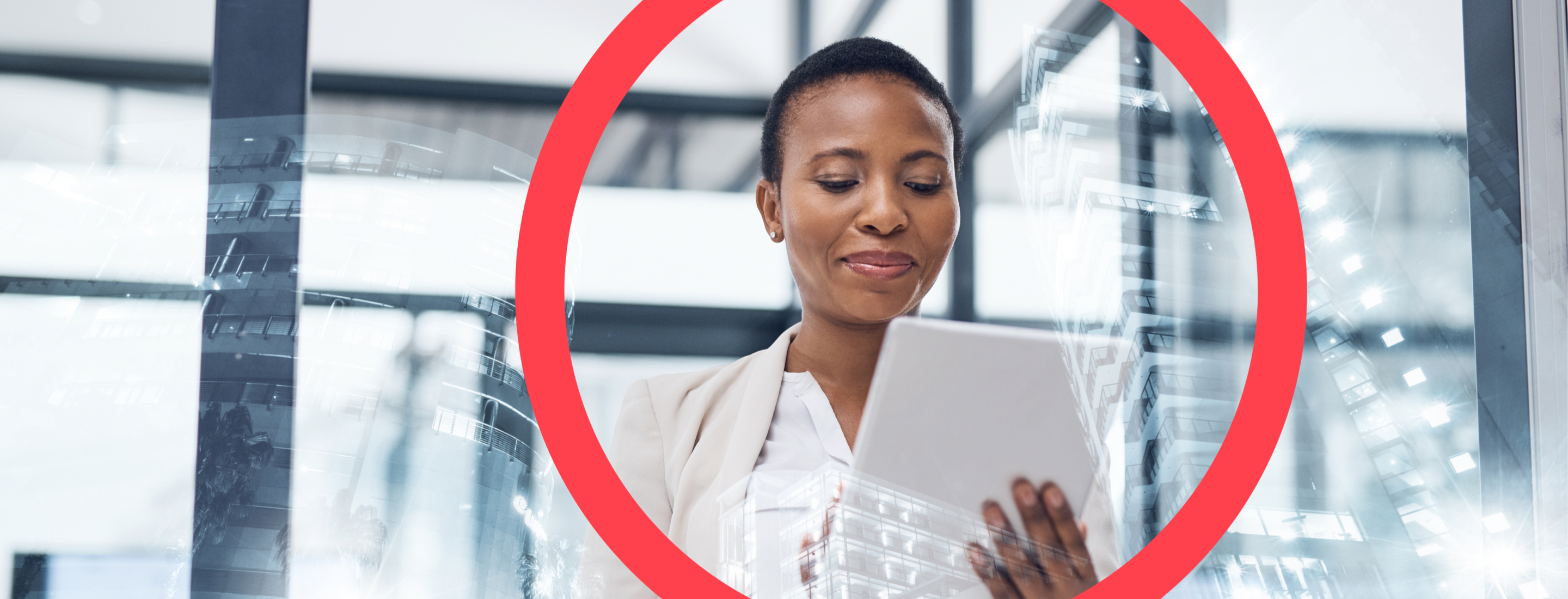 Woman holding tablet looking down against a background of glass windows reflecting office buildings