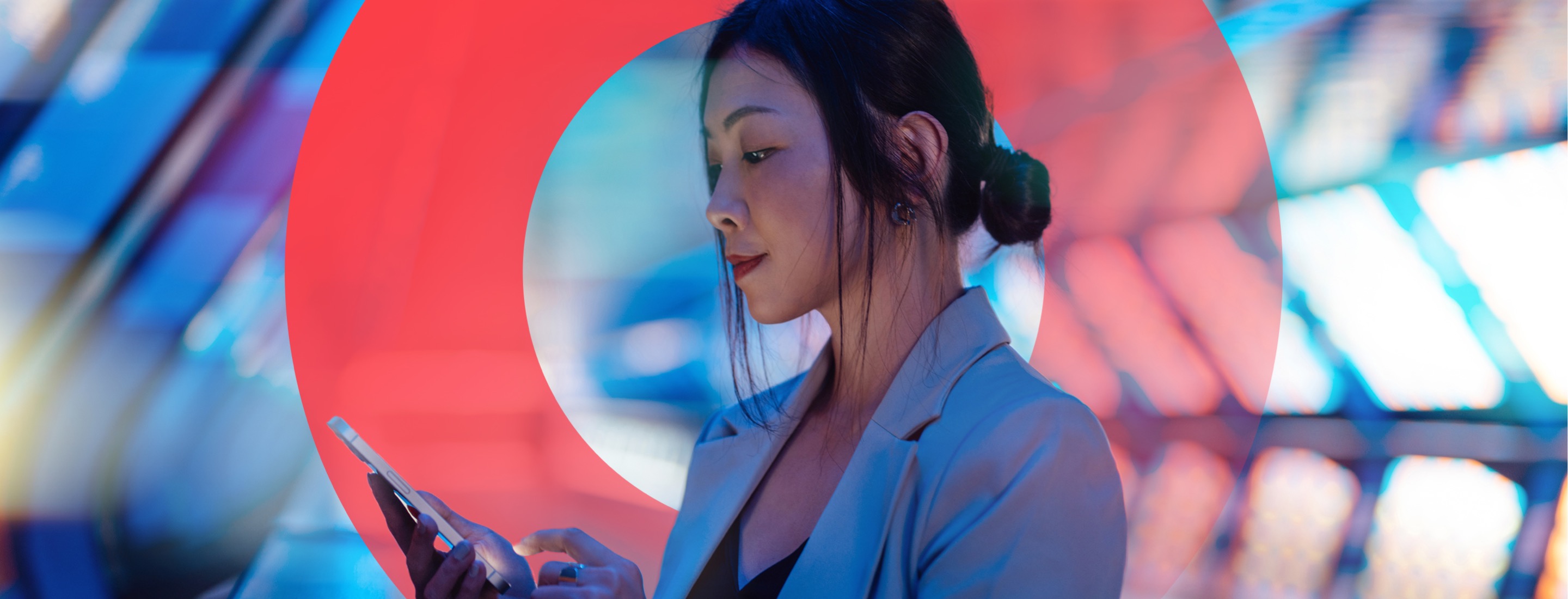 Woman looking at phone in hand and holding index finger above phone to tap