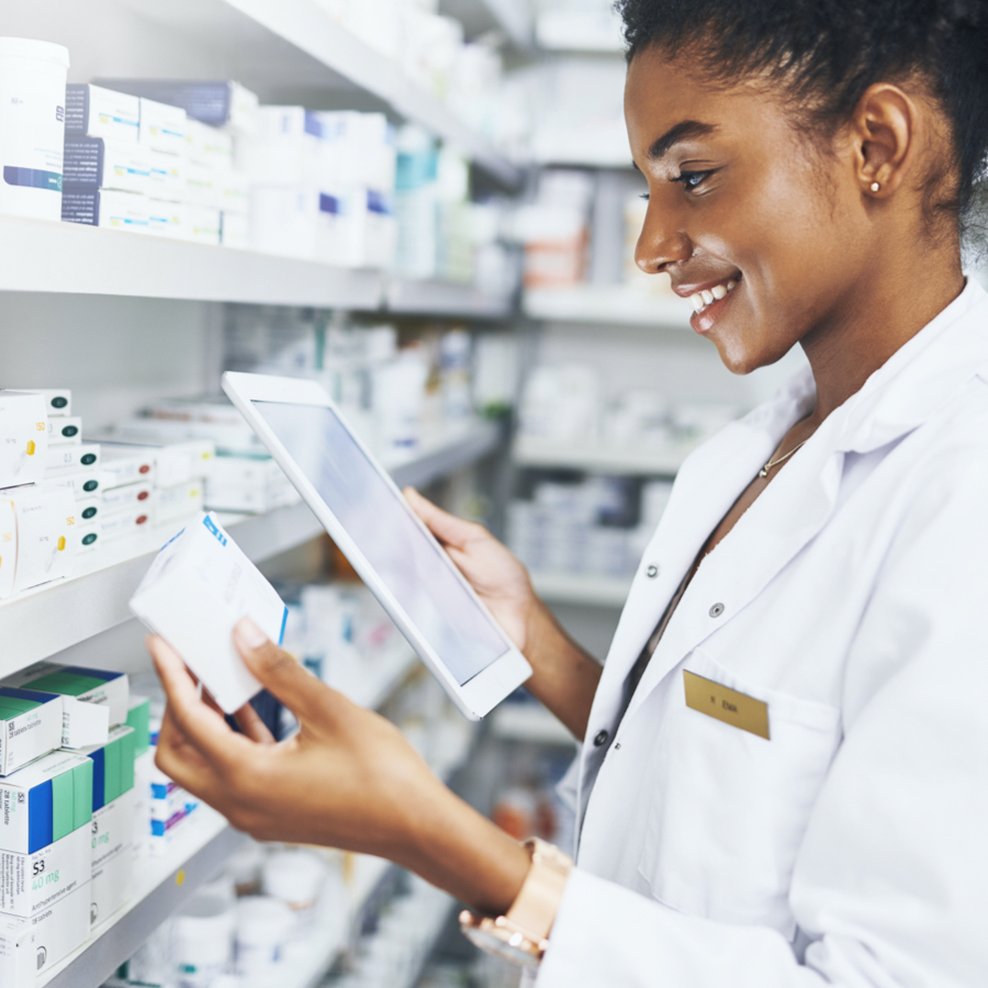 pharmacist using device to help select prescriptions off the shelf