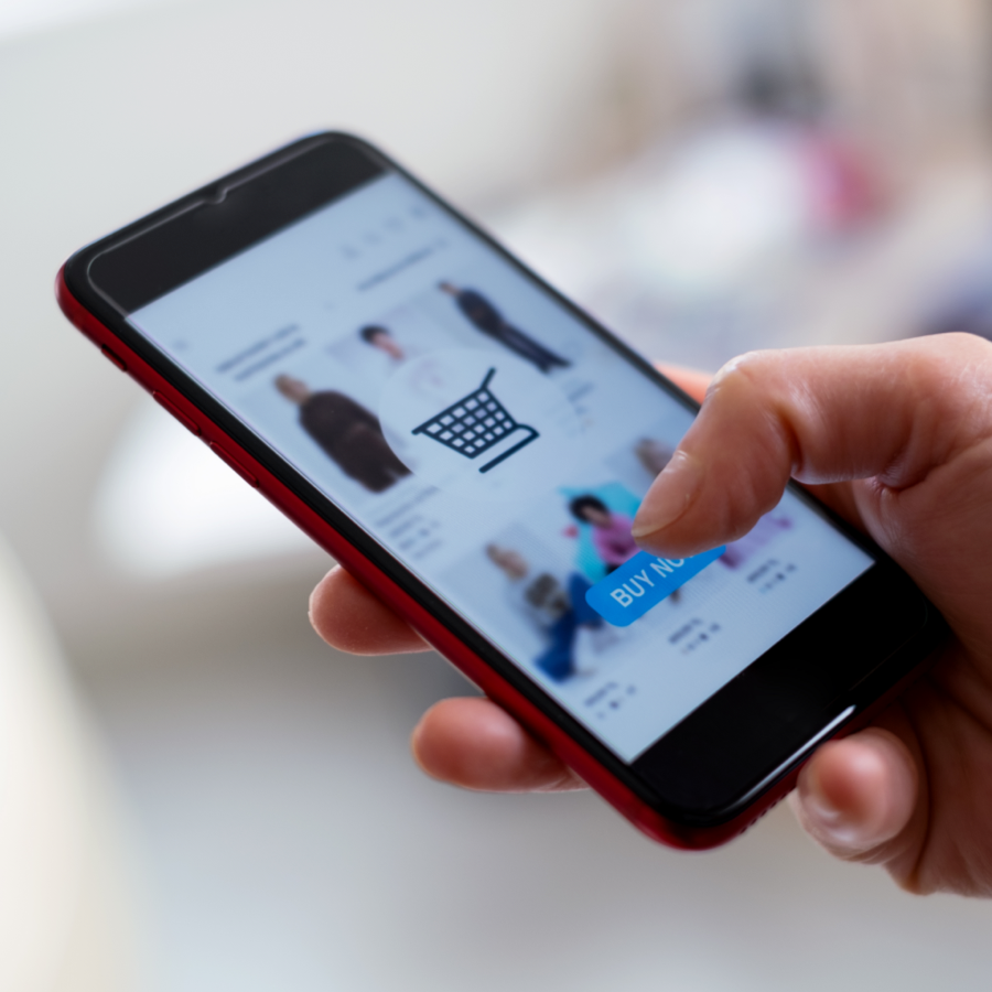 hand holding mobile phone using Amazon app