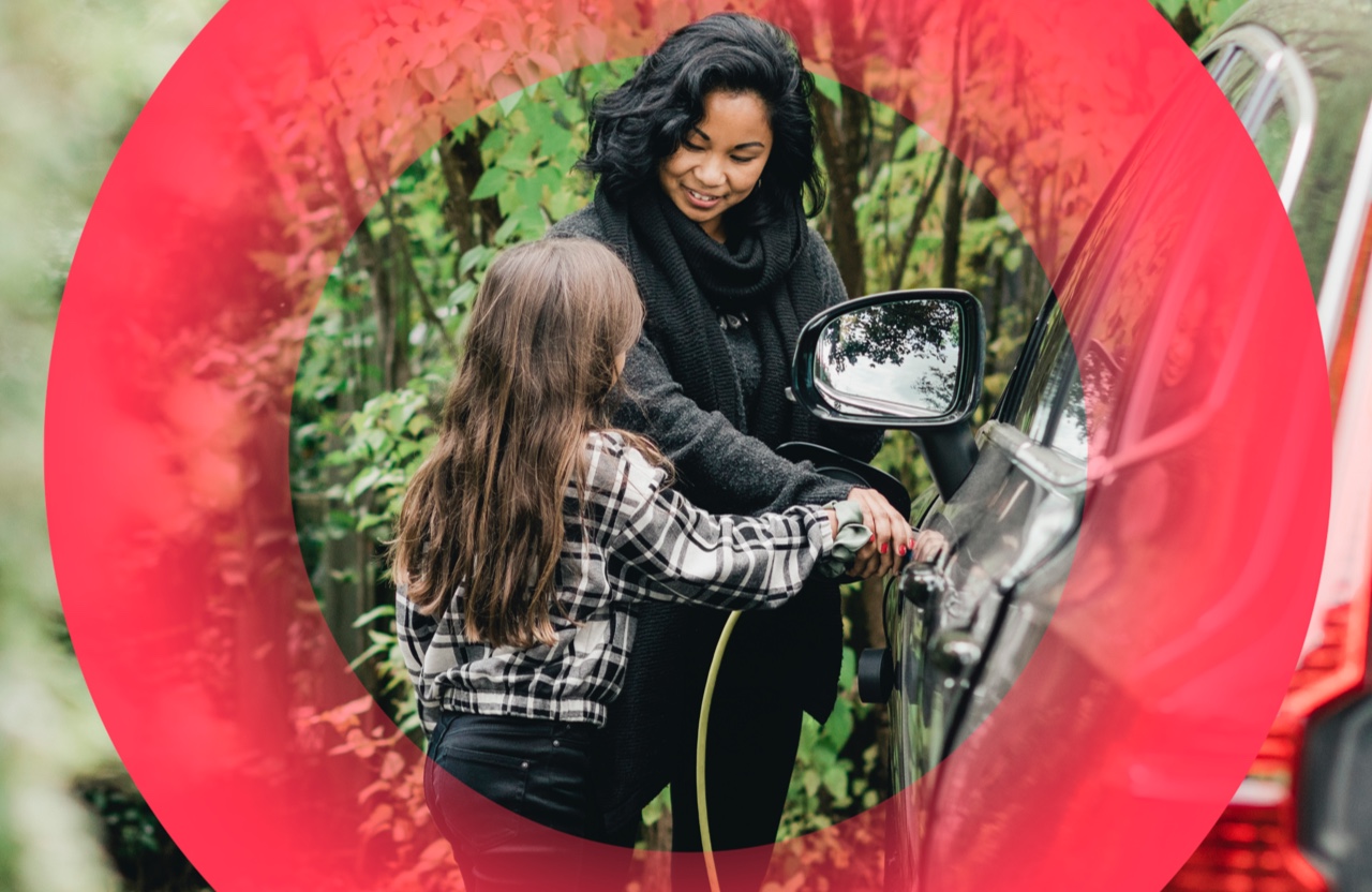 mother and child charging an electric vehicle