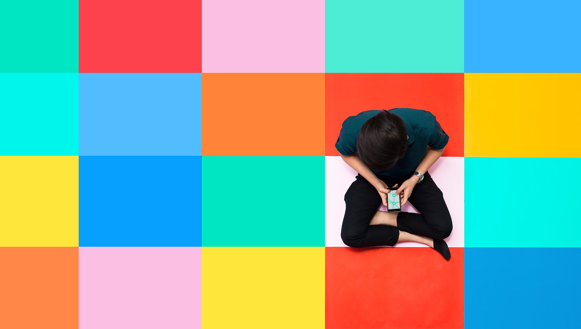 Person sitting on a colorful grid