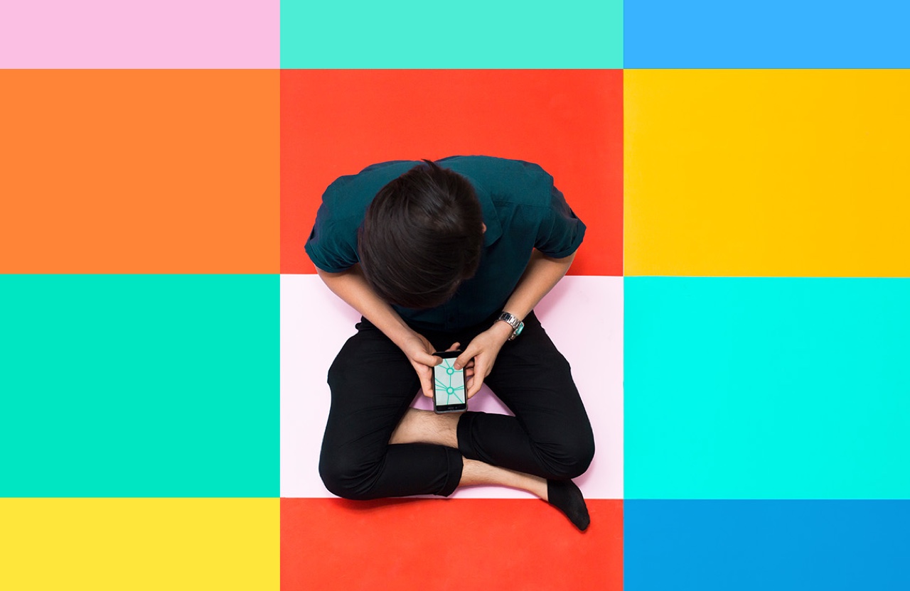 Person sitting on a colorful grid