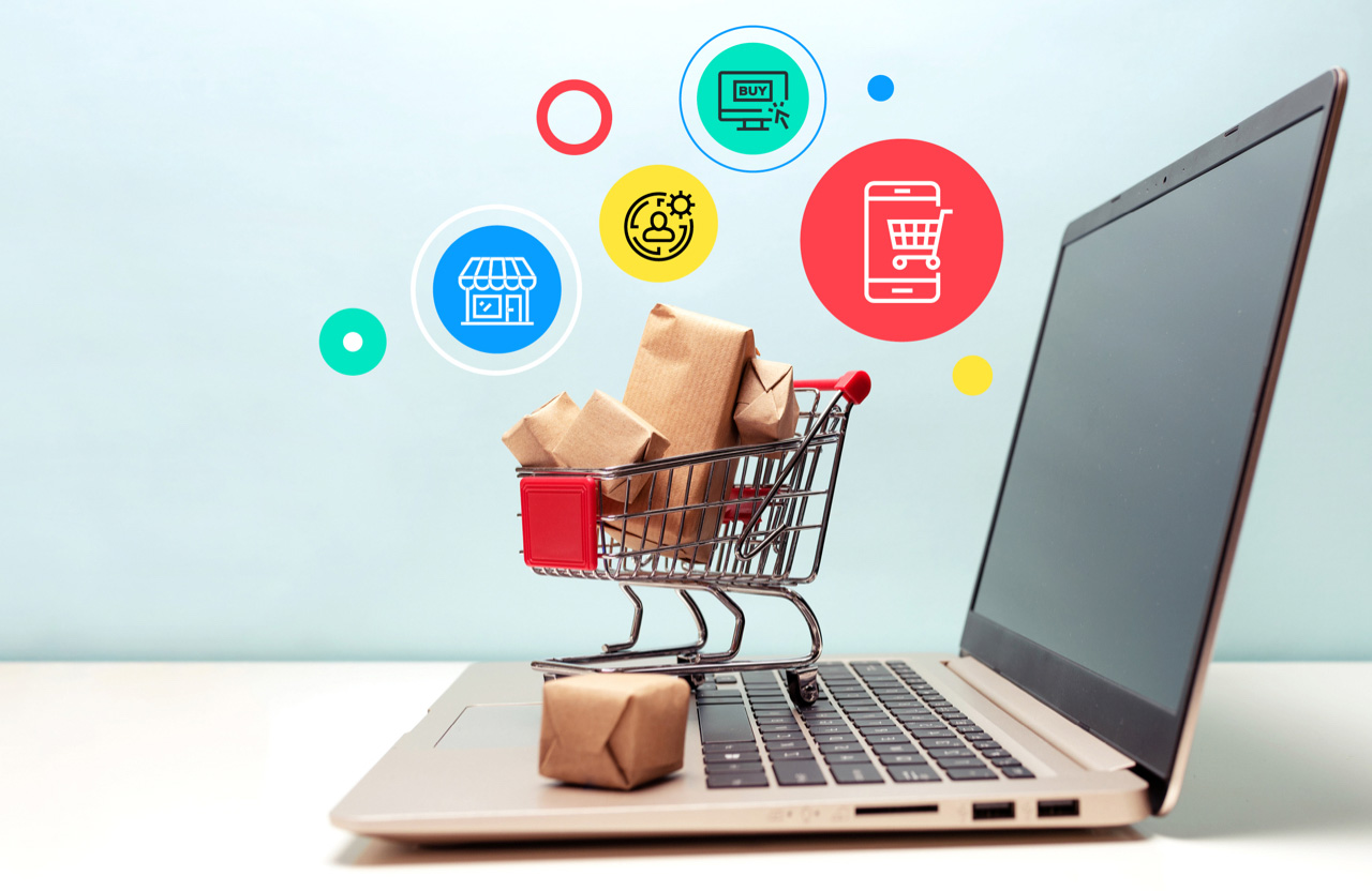 A tiny shopping cart sitting on a laptop keyboard