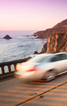 Car driving along the California coast