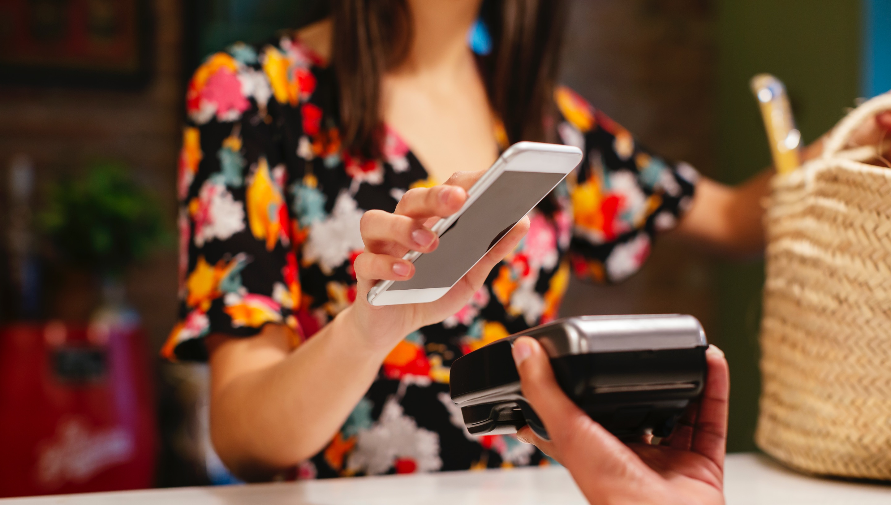 A person using an NFC mobile payment.