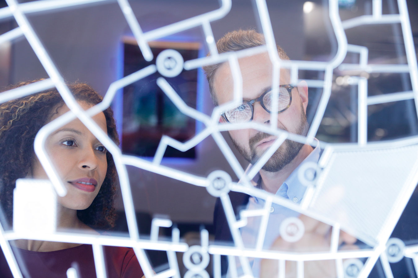 Two people look at a map of travel