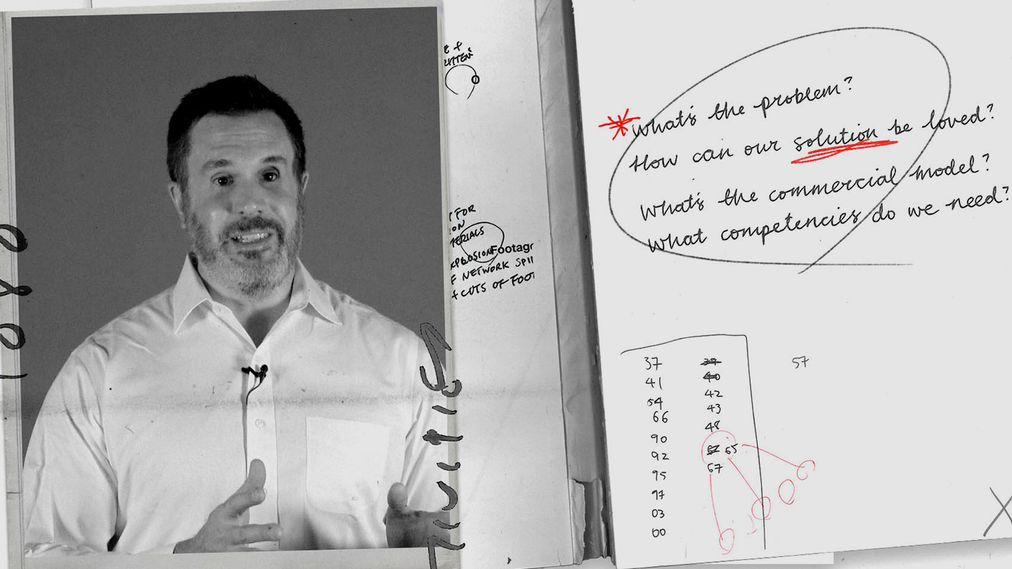 A person standing next to a dry-erase board.