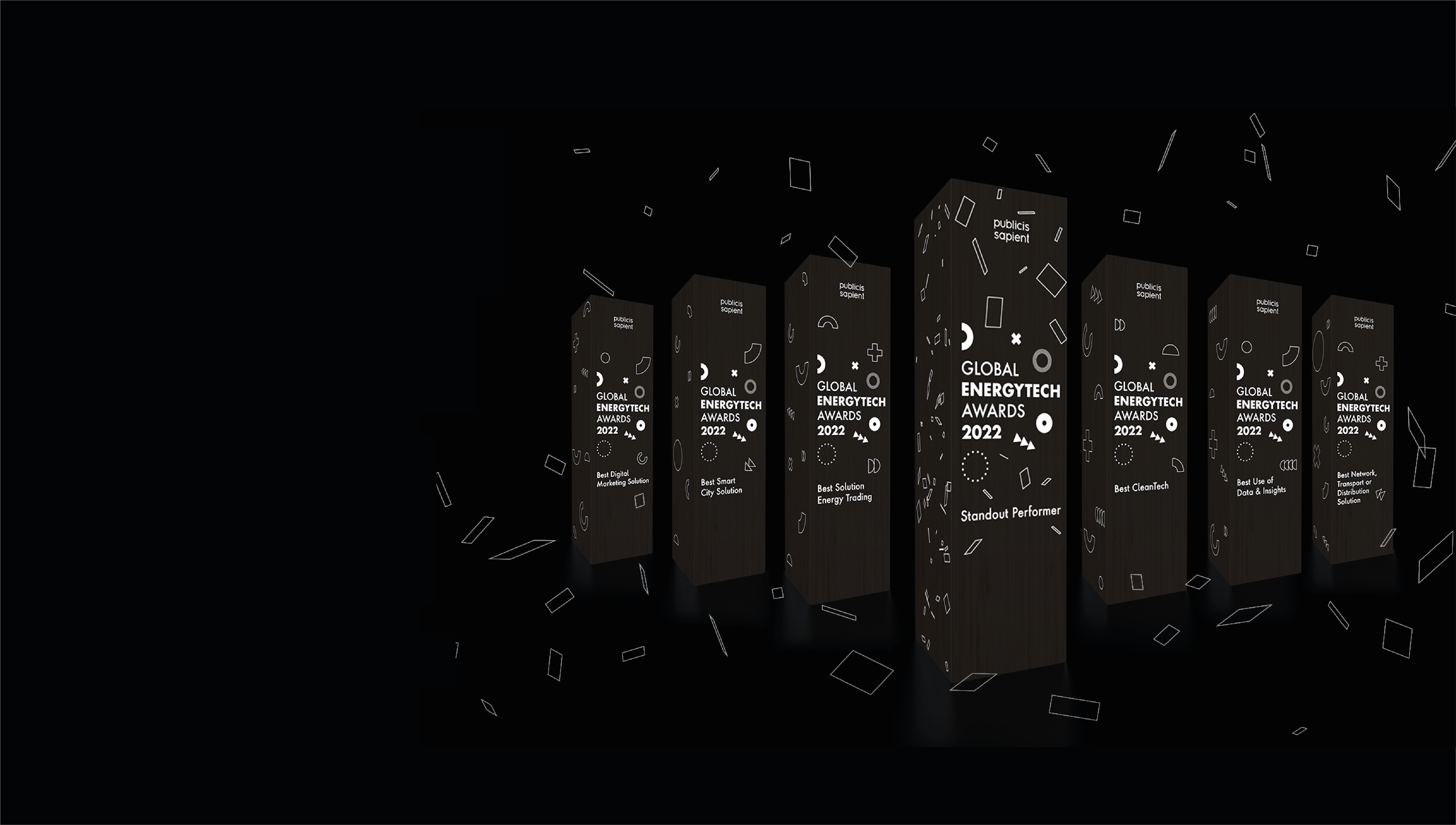 A black background with white confetti and the black EnergyTech Awards trophies lined up in a row.