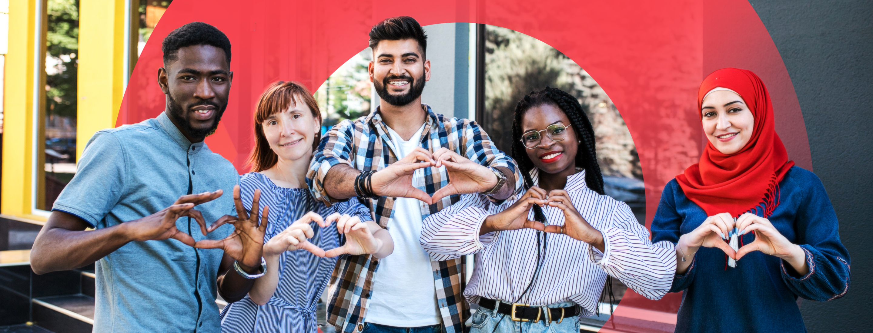 Five individuals (women and men) standing and smiling and forming a heart sign with their two hands 