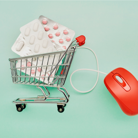 shopping cart filled with oversized pill containers attached to a computer mouse