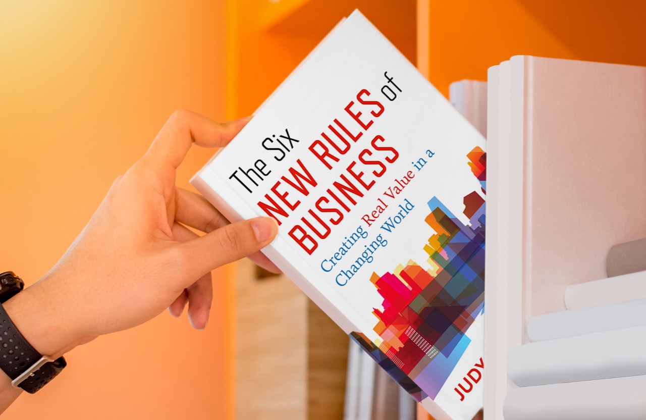 Image of person holding Judy Samuelson's book The Six New Rules of Business