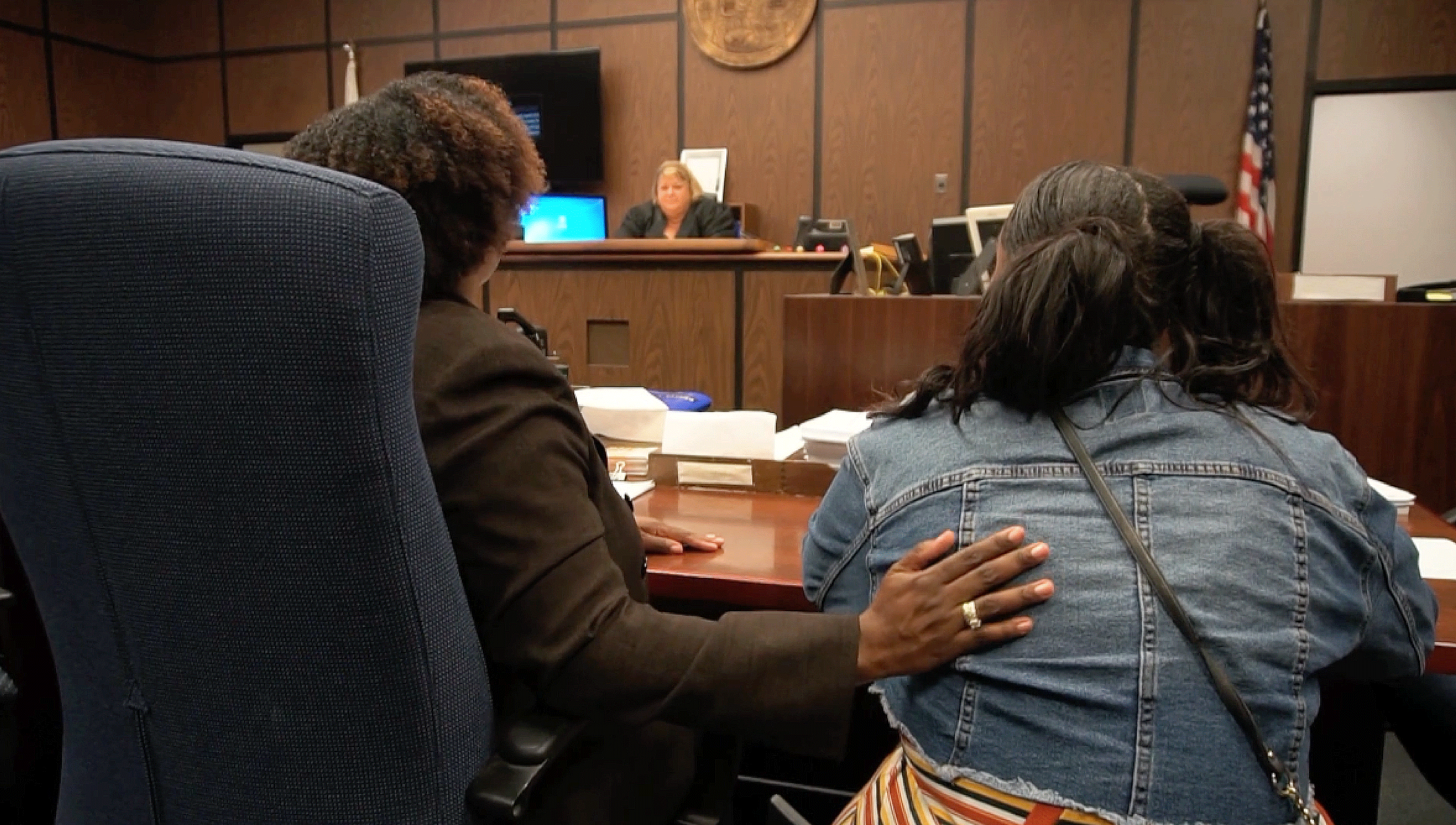 An attorney and client in a court room.