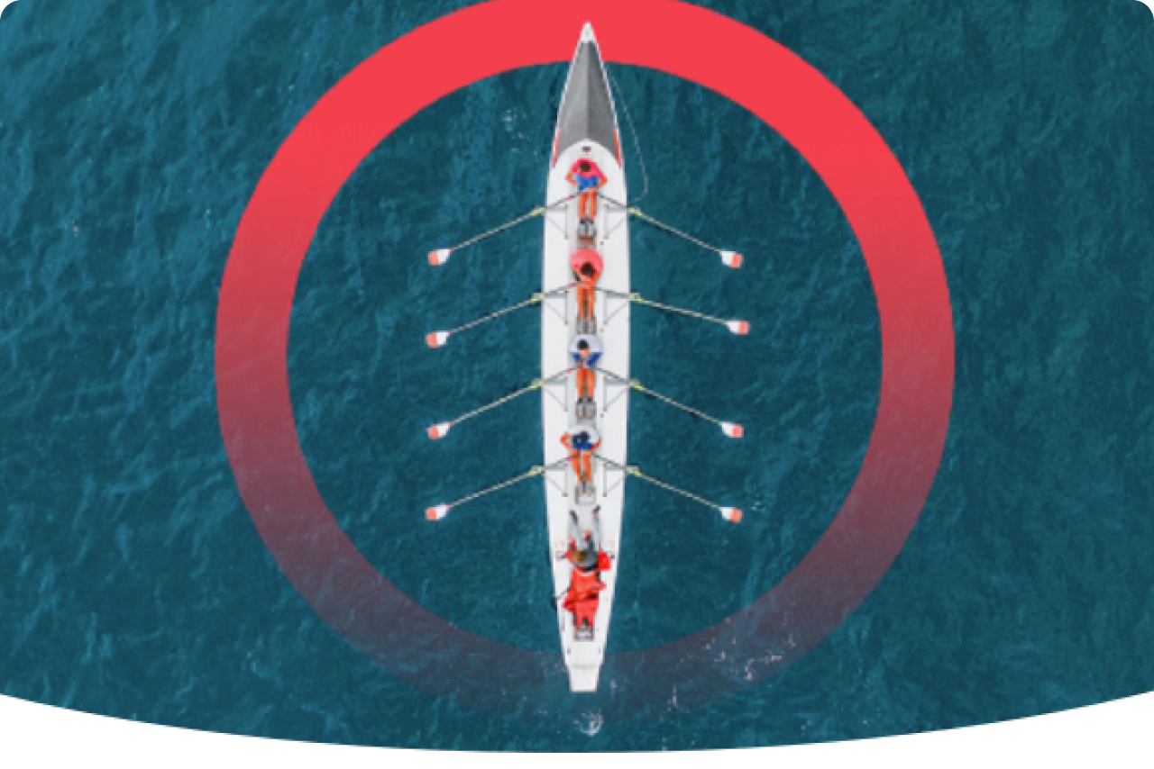Red aperture with aerial view of a sleek, narrow rowing crew boat cutting through calm water, its long oars extending outward in perfect symmetry.