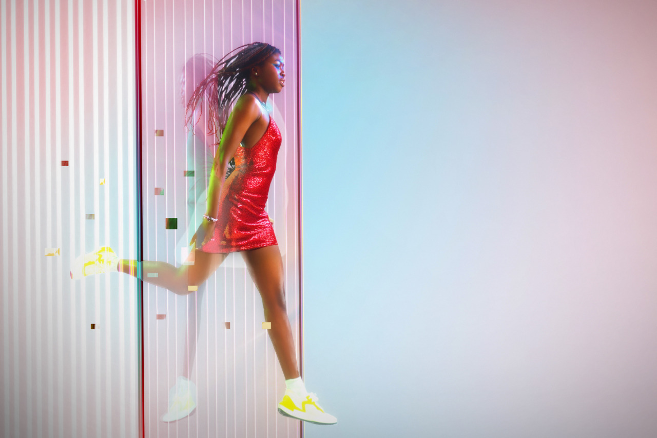 Woman leaping through data pixels