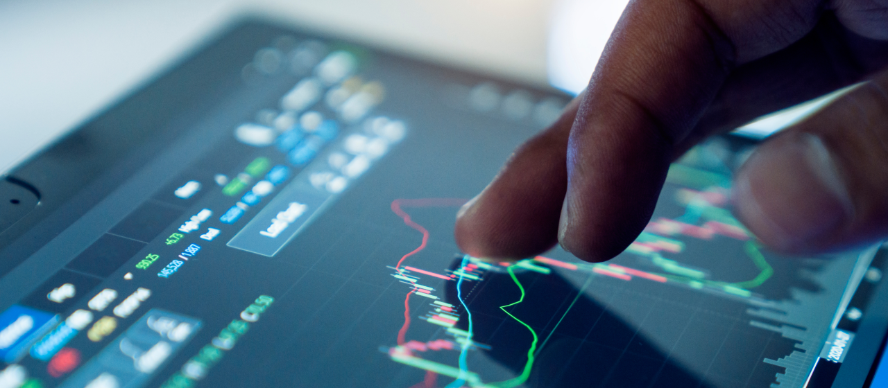 A finger swiping across a tablet showing graphical data