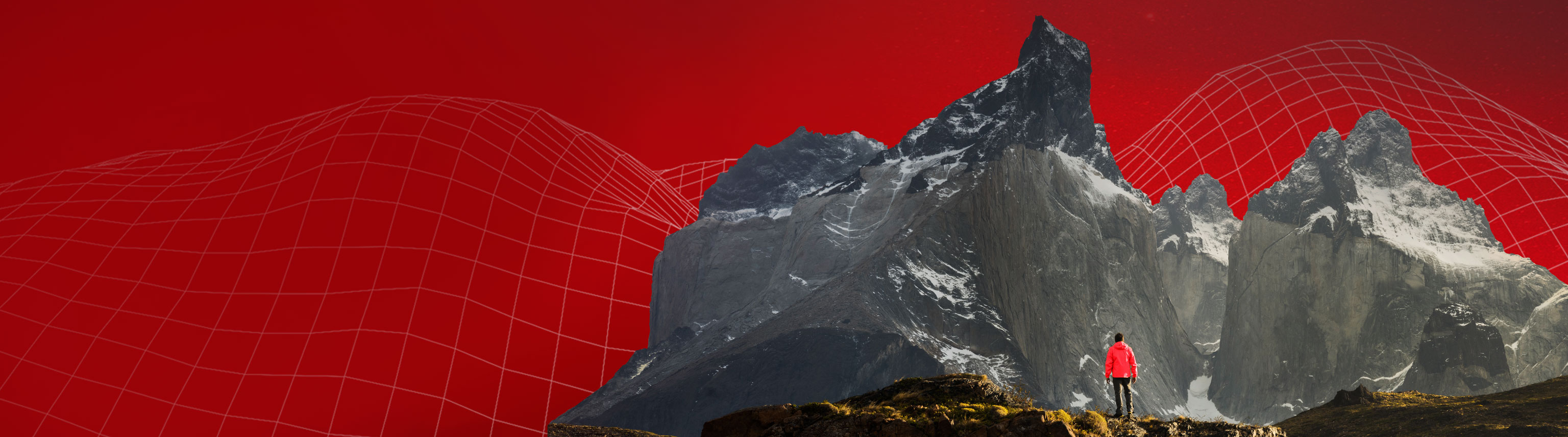 Person standing looking at mountain with red background