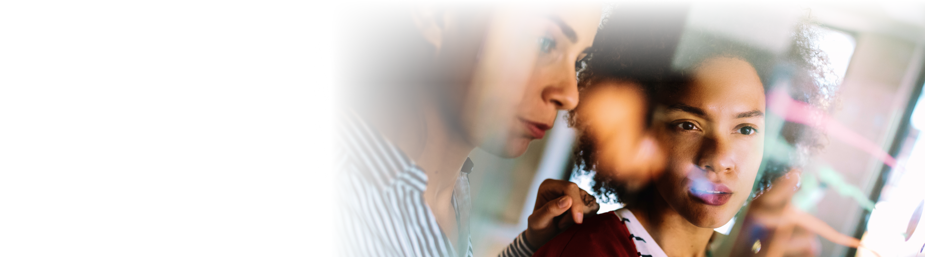 A man with glasses in a blue shirt looks at a large cutaway image of a jet engine
