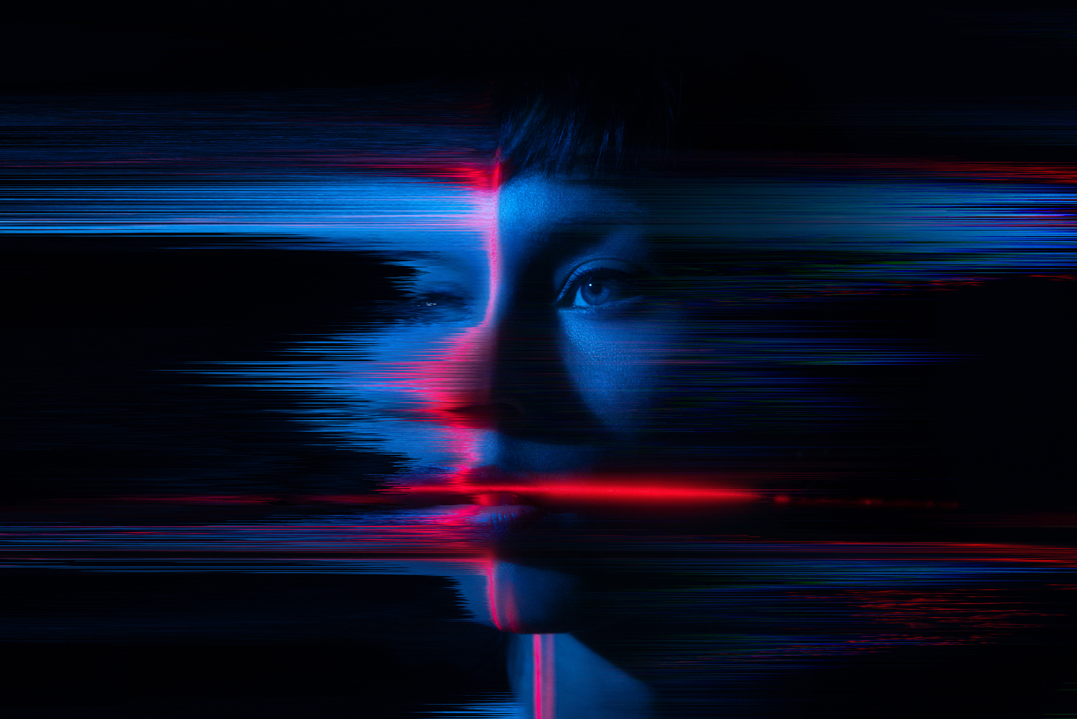 A woman is illuminated by dynamic red and blue lights, enhancing the atmosphere of the scene.