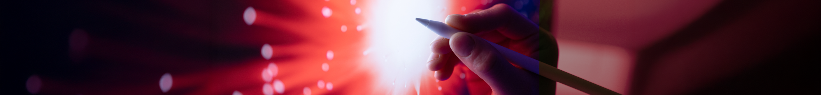 An abstract background showcasing a hand holding a pen with a mix of red and blue hues, creating a dynamic visual effect.